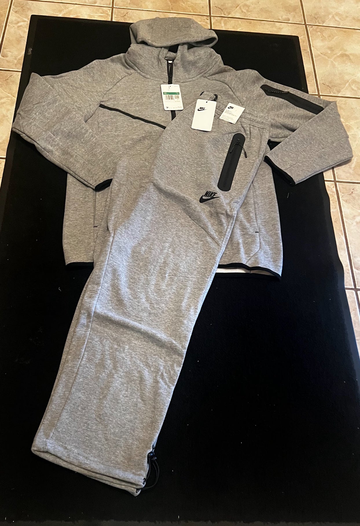 Gray Nike Tech sweatpants and hoodie